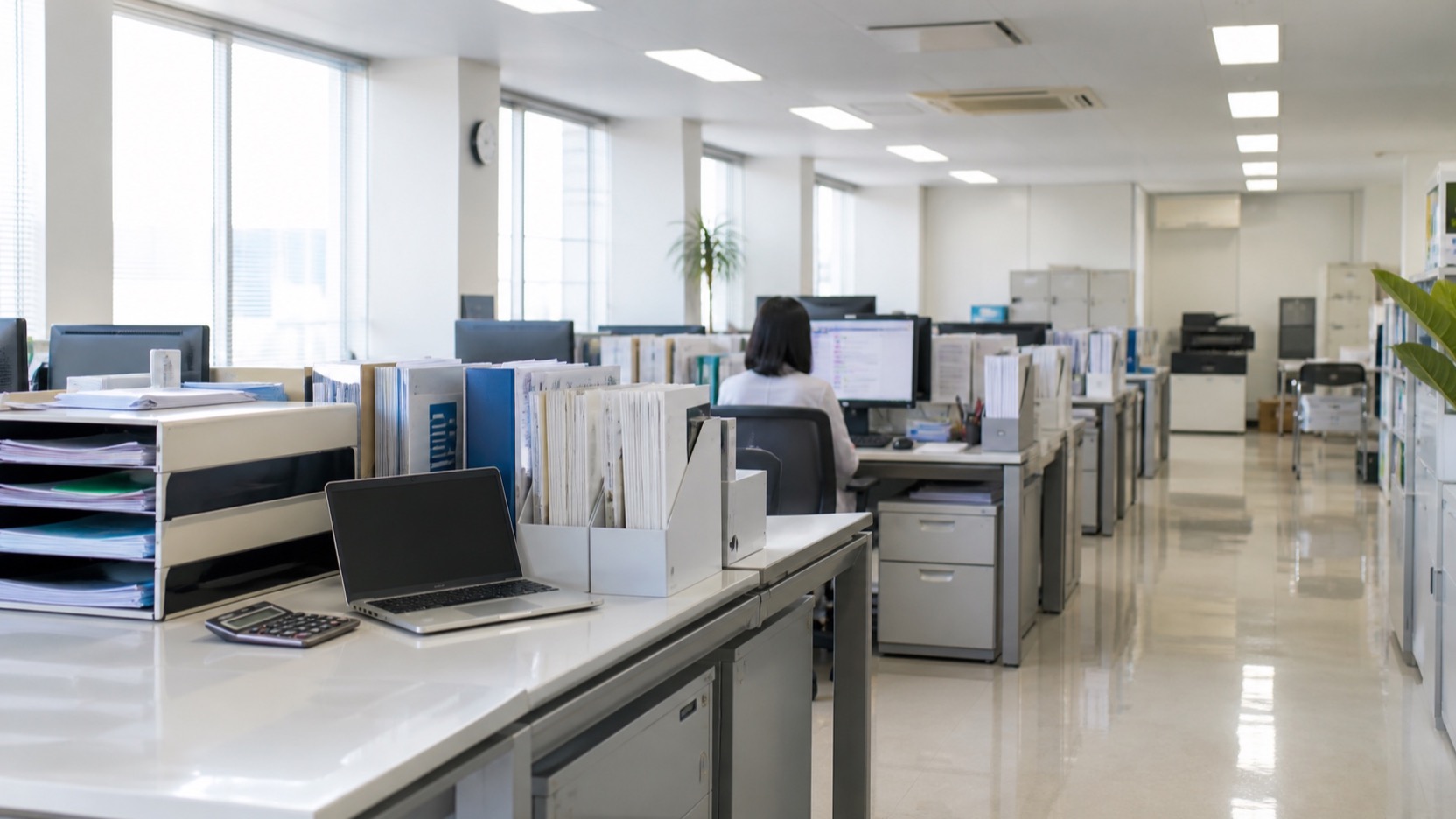 オフィスで社内の問い合わせに対応するスタッフ